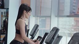 Athletic girl in the gym works out on an ellipsoid