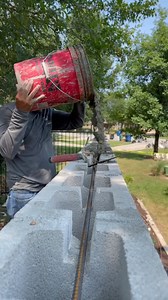 Grouting a CMU fence wall with concrete ((it has 2 bond beams) #construction #masonry #blocklayer #blocklaying | Paul S. Robertson