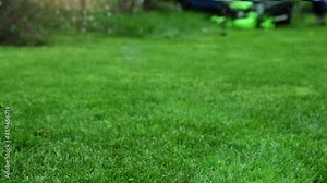 lawn mower in the garden in blur in the background