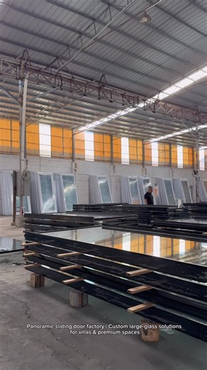 Remiski Panoramic Door Manufacturer on Instagram: "This is our panoramic sliding door manufacturing facility. Built with 8.0 mm thick aluminum profiles for large glass structures. Single panels reach up to 6 meters high and 3 meters wide. Motorized systems and tracks are fully tested before shipment. A stable and engineered door system for premium residential and project use"