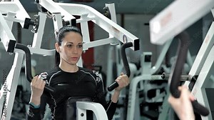 Sporty woman doing exercises the muscles of the back gym. Health, strength