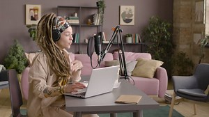 Woman With Dreadlocks Recording A Podcast Wearing Headphones | Free Stock Video Footage