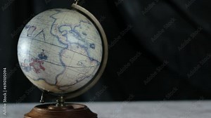 Globe in vintage style. hand spins the globe. learning and travel concept, 4k