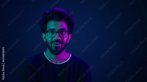 Shocked amazed astonish wonder excited Indian man coder hacker computer futuristic high-tech technology software user hacker looking shock wow in neon background hologram mock up infographic backdrop