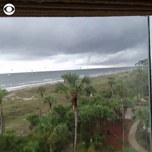 A waterspout was seen spinning in the distance on Hilton Head Island in South Carolina on September 2 following a warning from the NWS about hazardous weather conditions. | CBS News