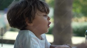 Playful kids turning in playground carousel Roundabout. Children having fun together outside