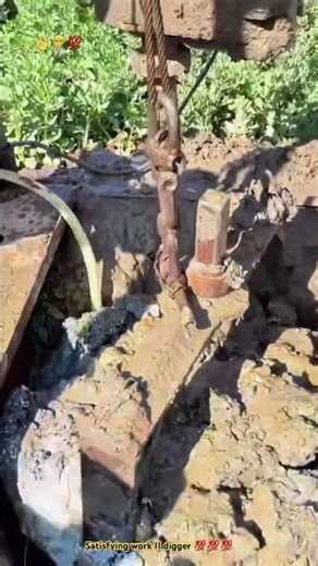 Traditional metal tool digging deeply well - Rudimentary but still good working