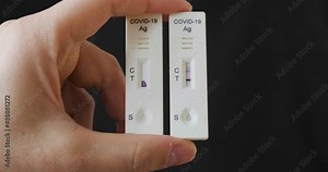 Two Covid-19 antigen cassettes side by side, one null, void, and one unclear. Concept of difficult diagnosis with self tests at home.