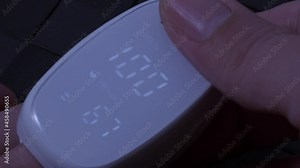 Oximeter usage. Finger pulse oximeter used to measure pulse rate and oxygen levels. Home self care during Covid 19 pandemic. healthcare monitoring concept. using portable fingertip pulse oximeter. 4k