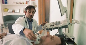 Mature endocrinologist check male patient thyroid gland using ultrasonography machine equipment, scanning endocrine system, check lymph nodes. Healthcare, medical insurance, regular health check-up