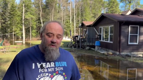 Rising floodwaters surround homes in northern Michigan