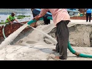 Sand Mining in Action: Powerful Water Jet Extraction Process on River Barge