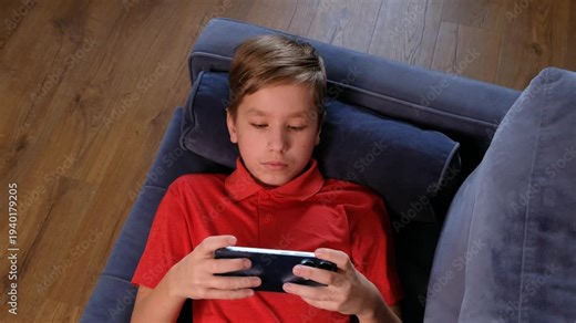12 Year Old Teenage Boy Using Smartphone at Home