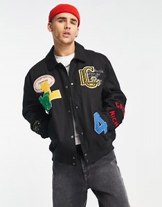 ASOS DESIGN oversized varsity jacket in black with badges | ASOS