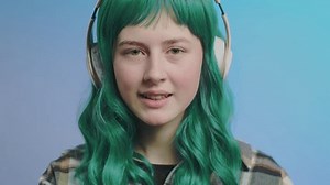 Generation Z, music subscription service concept. Portrait of authentic beautiful young woman smiling listening music in headphones