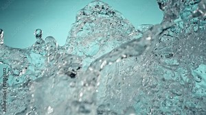 Super Slow Motion of Flying Water Splashes, Isolated on Blue Background. Filmed on High Speed Cinema Camera, 1000fps. Speed Ramp Effect.