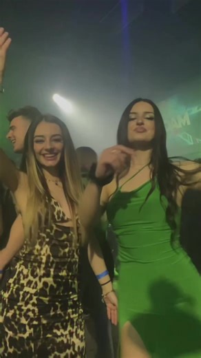Energetic Dance Duo in Nightclub Setting