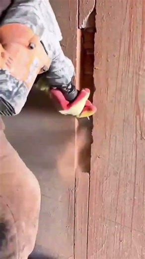 Carving vertical grooves in a brown wall using an electric wall chaser
