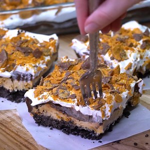 You won't find a more delicious dessert than this cool and creamy BUTTERFINGER LUSH. Layer after layer of heaven! Recipe: https://spicysouthernkitchen.com/butterfinger-chocolate-and-peanut-butter-lush/ | Spicy Southern Kitchen