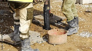 Close-up of soil sampling during pile drilling process. Extraction of subsurface material for geotechnical analysis and foundation assessment