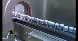 vaccine filling process drug vial in a medicine factory creative view of small vials collected for manufacturing small glass injection moving in a pharma equipment machinery pharmaceutical industry