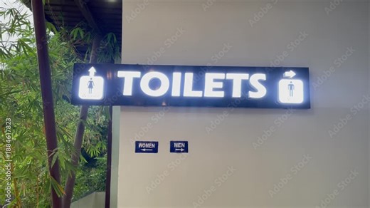 Public Toilet Signage with Male and Female Icons on Modern Restroom Entrance