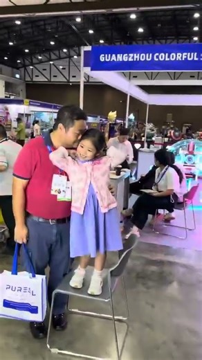 Watching People Use a Photo Booth at an Exhibition