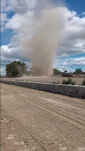 Towering Dust Devil Swirls Across Dusty Field