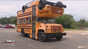 Step on board the topsy turvy bus. It runs on solar power and veggie oil