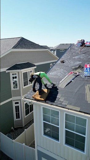 This is how roofers install shingles on the edge of a two story house! 🤯 #roofing #construction