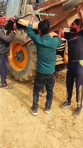 The process of unscrewing a wheel from a front loader using a wheelbarrow