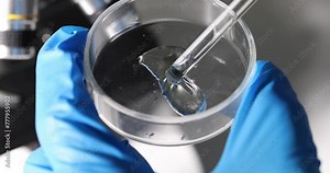 Scientist holds petri with toxic gel liquid and pipette in laboratory