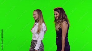 Window shopping of two fashionable female friends over green screen. Getting to a window, looking, and entering. 3 takes.