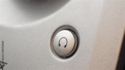 Finger press turn on headphone symbol button key home theater system the button lights up blue