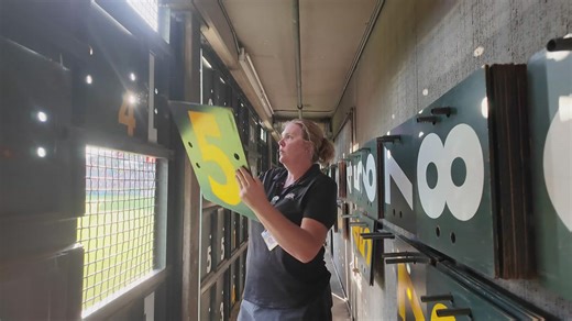 How does the manual scoreboard at Coors Field work?
