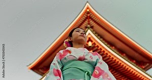 Woman, Japanese shinto temple and traditional clothes for culture, building or religion in sunshine. Person, ideas and vision for buddhism with faith, mindfulness or thinking with low angle in Kyoto