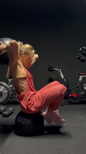 Demand the core to switch on and work. Weighted ball behind neck, slight tilt in torso, balancing on another weighted ball aim to keep the feet off the ground.