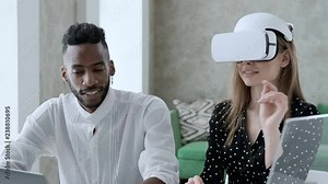 Young designers creation of the project, using new technologies of augmented virtual reality. Future is now. Two students touch something using modern virtual reality glasses.