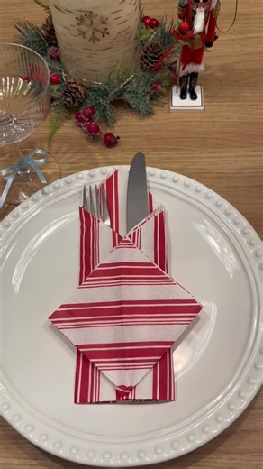 @lifehack_withlu on Instagram: "Easy Christmas napkin fold 🎄✨ This simple napkin folding idea holds your silverware neatly and makes your holiday table look elegant in seconds. Perfect for Christmas dinner, holiday hosting, and festive table settings. #ChristmasNapkin #NapkinFolding #ChristmasTableSetting #HolidayHosting #TableDecorIdeas #ChristmasDecor #HostingTips"