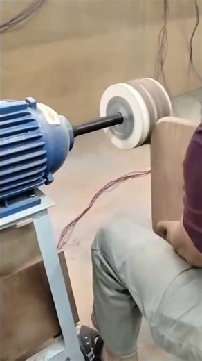 polishing and smoothing the edge of a wooden board using a powerful industrial grinding machine
