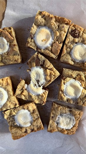 S’mores Cookie Bars These S’mores Cookie Bars will be the dessert of the summer! They give me 90’s nostalgic summer vibes, and definitely make me think of my childhood sitting around a campfire making s’mores! Ingredients: -1 stick room temp butter (1/2 cup) -1/4 cup brown sugar -1/4 cup white sugar -2 egg yolks -1 tsp vanilla -1 cup all purpose flour -1/2 tsp baking soda -1/4 tsp salt -3 sheets graham crackers, gently crushed -10 Hershey squares, roughly chopped -3 marshmallows, cut into thirds