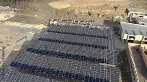 Aerial circling view of Construction of a solar power plant and installation of solar panels. Construction of an alternative energy power plant.