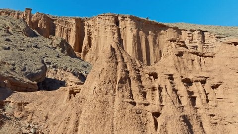 clip-4017099451-majestic-eroded-sandstone-cliffs-rise-under-clear