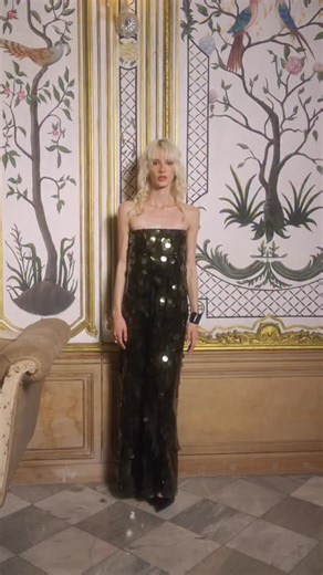 A column of liquid green, sheathing you in soft, metallic moss. The paillettes act as scales, each one catching and changing the light, creating a flare of shimmer that moves like a quiet, glamorous shadow. Off-Shoulder Paillette Dress Olive-green paillette off-shoulder maxi dress with a gentle flare towards the hem. Keyhole with button closure at the back. Slit in the side. Comes with adjustable, detachable straps. Garment is fully lined. . . . . . [olive green sequin dress, paillette maxi dres