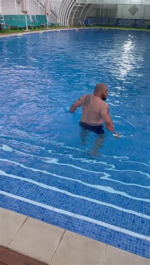 Adult Male Enjoys Relaxing Day at Indoor Swimming Pool