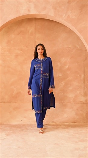 Kayseria on Instagram: "A tribute to mid-19th century Chinese artistry — this blue viscose karandi pret set features a dyed and exquisitely embroidered shirt, adorned with horses, elephants, peacocks, and scenic landscapes inspired by a historic Han woman’s jacket. Intricate grid embroidery is elevated with hanging bead tassels along the neckline, sleeves and along every edge of the grid, adding a touch of refined movement and luxury. SKU: MCP2041-2 #masterscollection #kayseria #pret #winter25 #