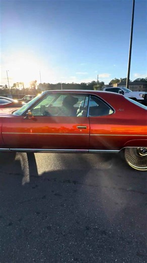 Candy tangerine Chevy fastback on 26's