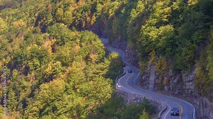 Captured by drone, this footage highlights the winding New York State Route 97, Hawk's Nest, in Sparrow Bush, Orange County, showcasing the scenic Delaware River views and vibrant autumn colors. Stock Video