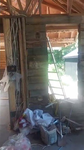 Log Home Build - Cleaning the inside logs with a wire brush to remove the darkness before staining.