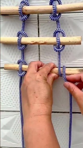 Simple rope ladder with knots on wooden rungs